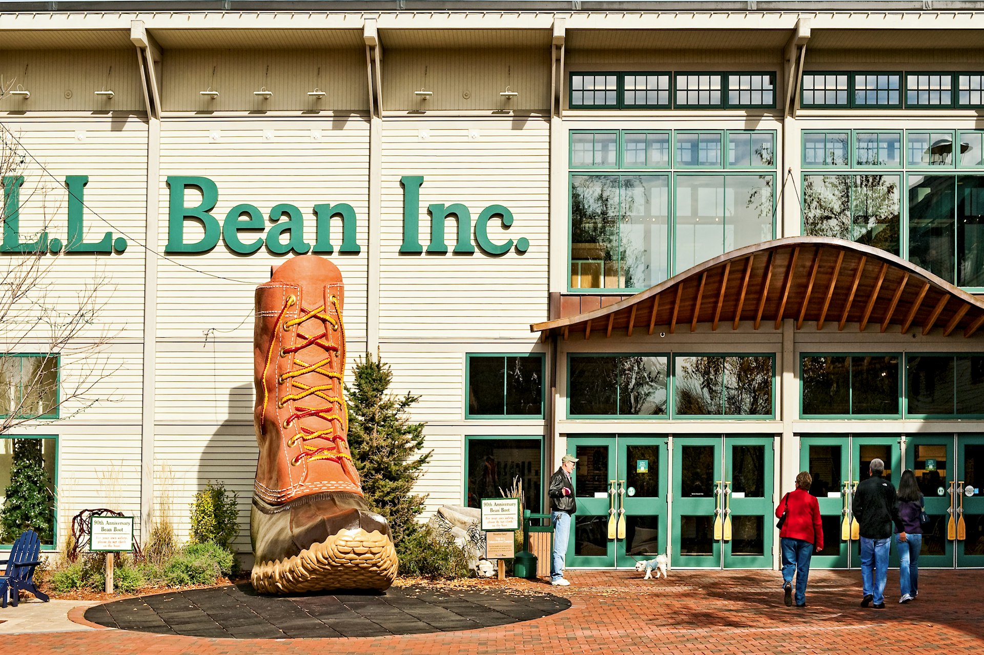 Shoppers walking into the LL Bean flagship store in Freeport, Maine, on a sunny day