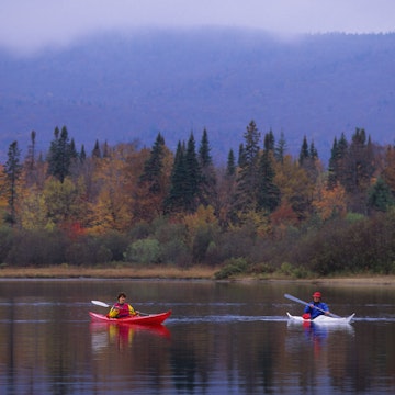 QUEBEC, CANADA - 1992/10/15: People kayaking in the fall on Lake Lac-Monroe, Mont-Tremblant National Park, in the Laurentians in Quebec Province, Canada. (Photo by Wolfgang Kaehler/LightRocket via Getty Images)