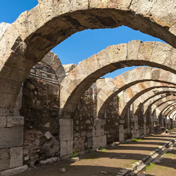 Empty corridor with arcs and blue sky. Ruins of Smyrna