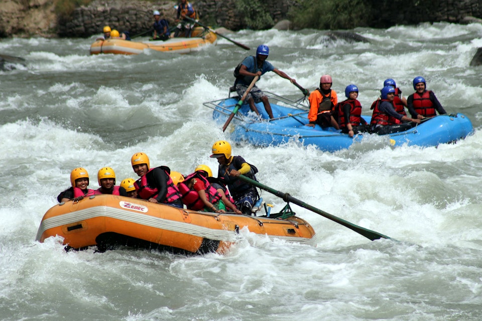 MANALI, INDIA - MAY 13: Tourists enjoying rafting in Beas river at Kullu on May 13, 2015 near Manali, India.  Adventure water sports centre near Kullu provide exhilarating experience for the tourist. Along with rafting enthusiasts can also enjoy activities like Kayaking. (Photo by Aqil Khan/Hindustan times via Getty Images