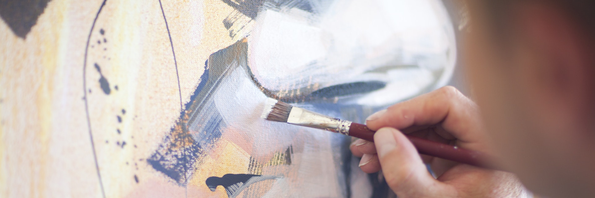Close up of mature male artist working on canvas