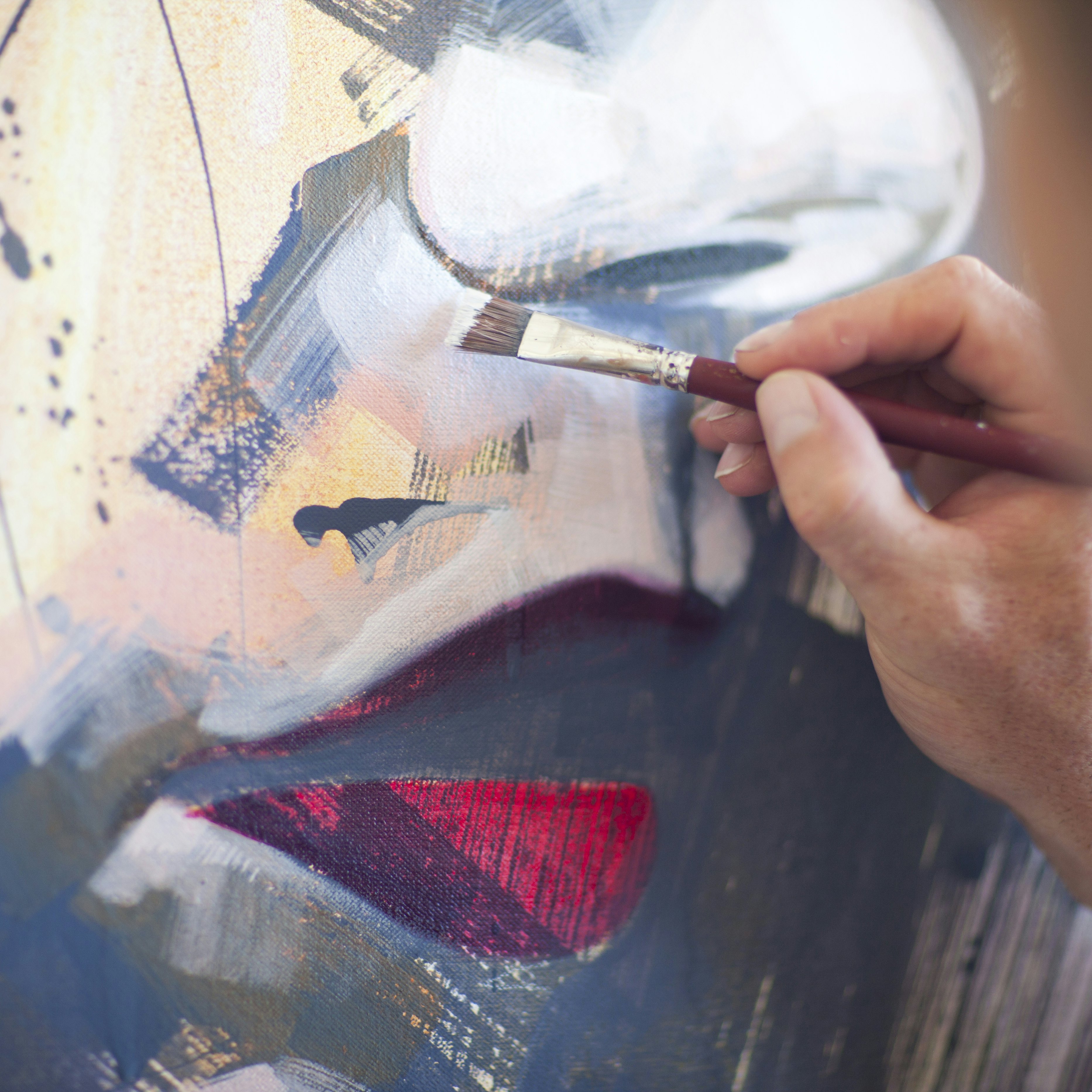 Close up of mature male artist working on canvas