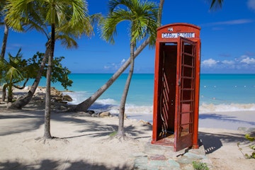 Beach and red telephone box, Dickenson Bay, St. Georges, Antigua, Leeward Islands, West Indies, Caribbean, Central America