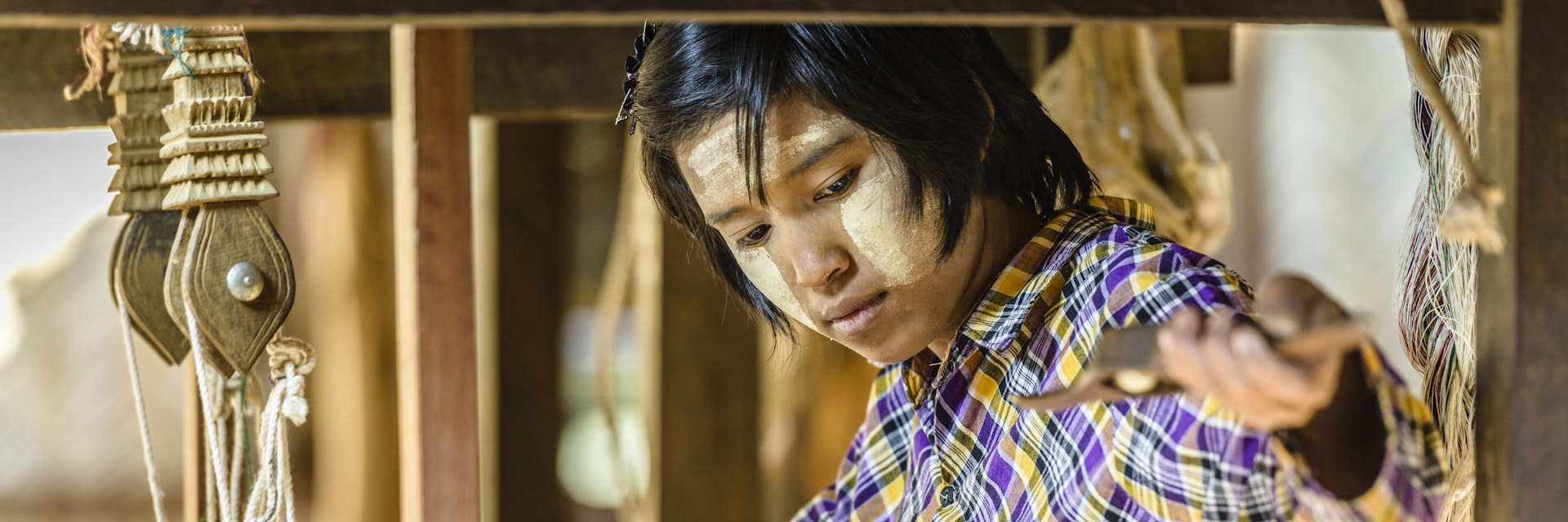 Asian girl weaving fabric
