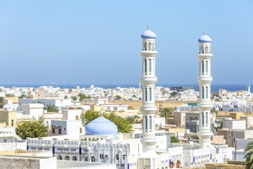 Oman, Sur, Cityscape with mosque in foreground