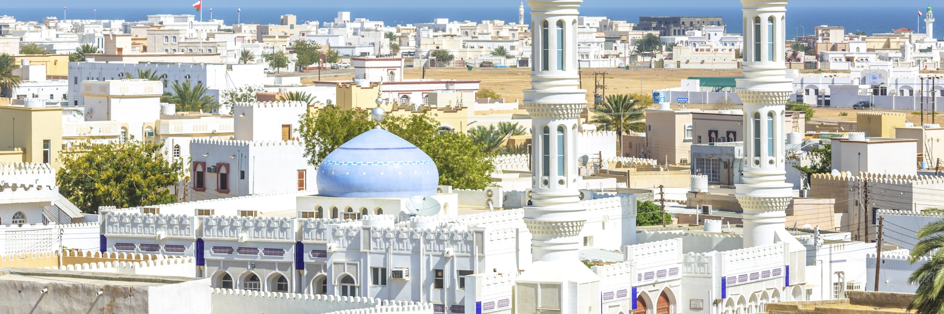 Oman, Sur, Cityscape with mosque in foreground
