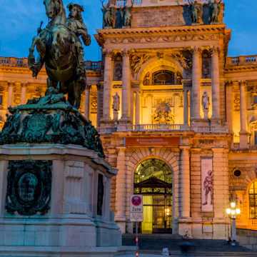 Austria, Vienna, view to lighted Hofburg Palace at twilight