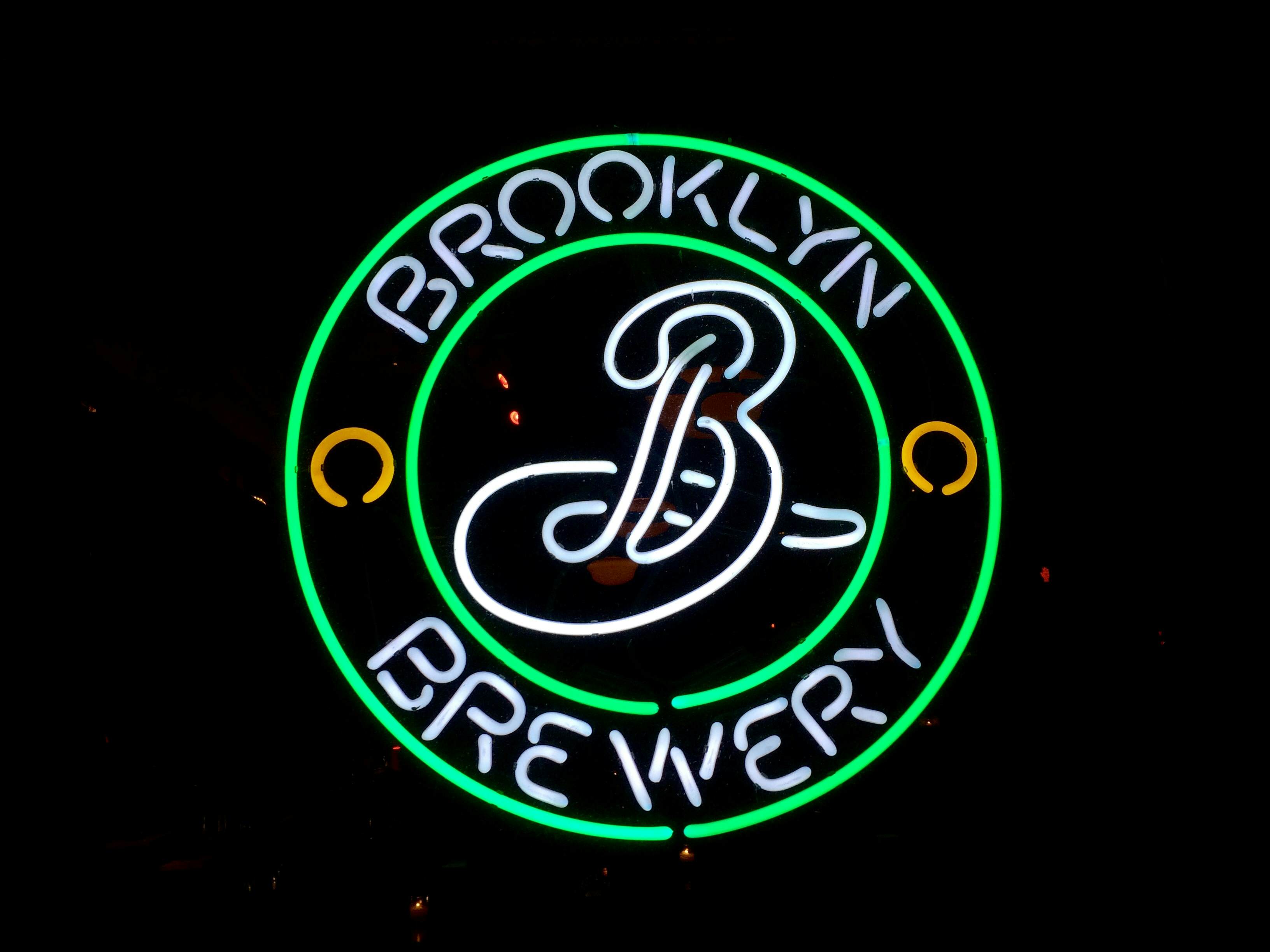 Neon sign at night: The Brooklyn Brewery beer logo is displayed in the front window of a bar in Prospect Heights, Brooklyn, NYC- February 28, 2015