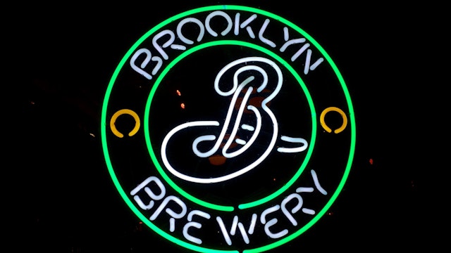 Neon sign at night: The Brooklyn Brewery beer logo is displayed in the front window of a bar in Prospect Heights, Brooklyn, NYC- February 28, 2015