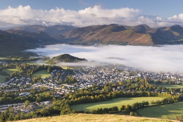 Keswick and mist covered Derwent Water at dawn, Lake District National Park, Cumbria, England, United Kingdom, Europe
