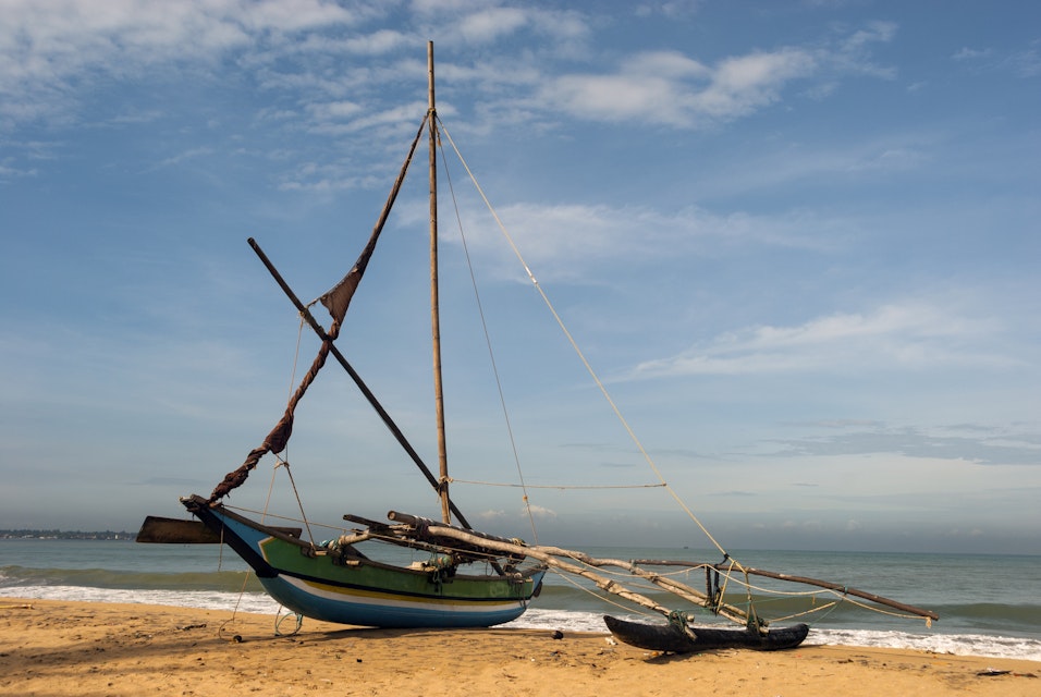 Outrigger fishing boat on beach