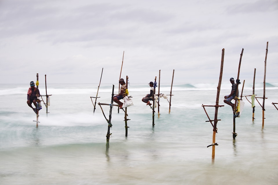 Sri Lanka, Weligama, Stilt fishermen on the coast