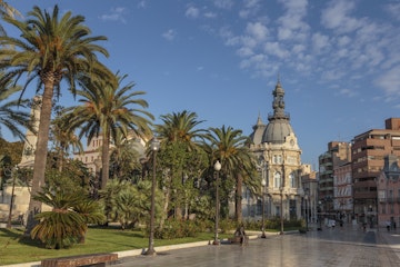 Town Hall under a cloud dappled blue sky with palm trees and roses, Cartagena, Murcia Region, Spain, Europe