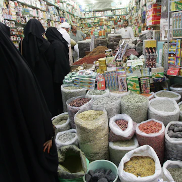 Jeddah, SAUDI ARABIA: Saudi women shop at a grocery in the Souq al-Alawi market in the old town of Jeddah 29 December 2005. The market is the biggest market in Saudi Arabia where hundreds of thousands of Muslims from different countries have so far arrived for the annual pilgrimage to Mecca which begins on January 7. AFP PHOTO/BEHROUZ MEHRI (Photo credit should read BEHROUZ MEHRI/AFP/Getty Images)
