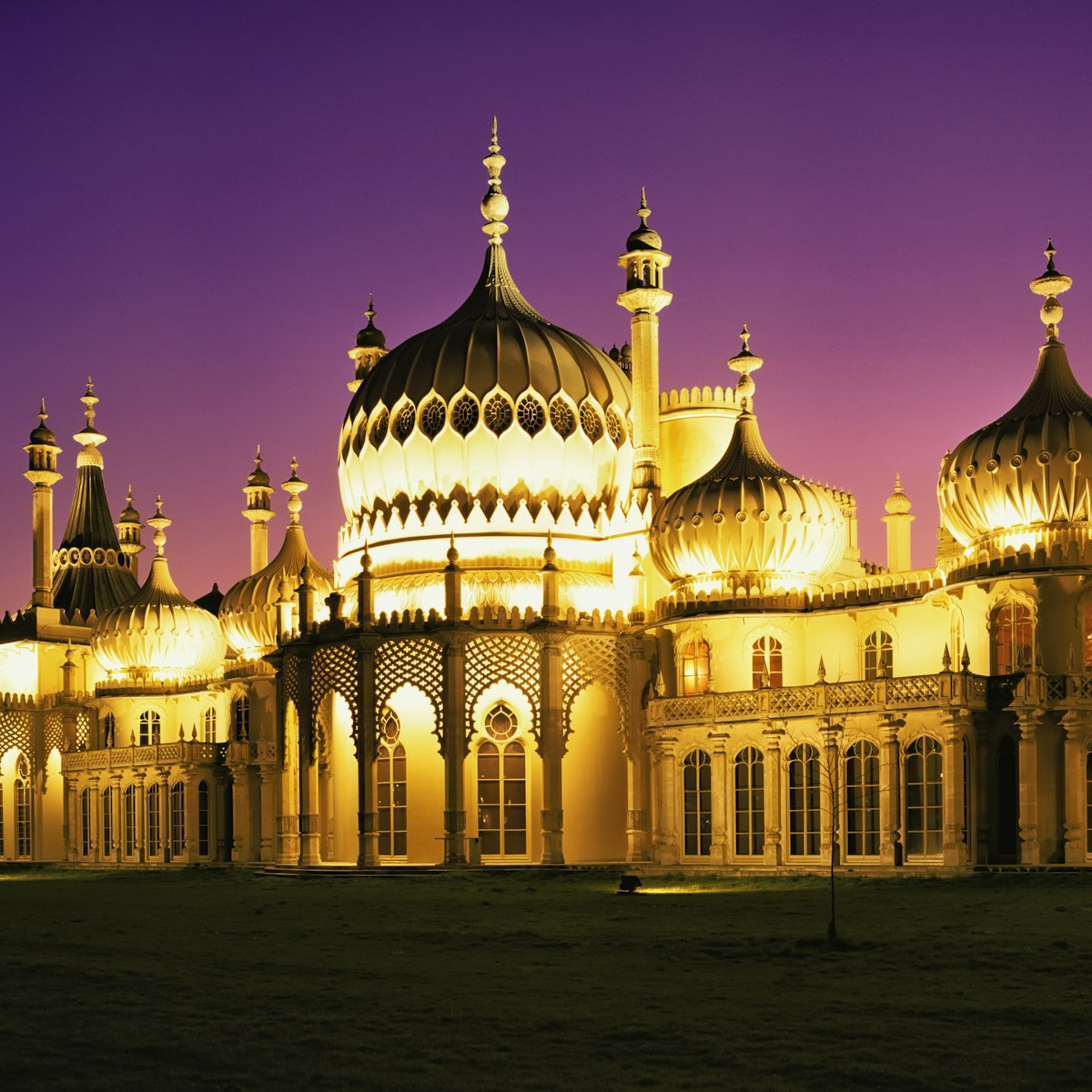 Illuminated Brighton Pavilion building at dusk, Brighton, Sussex, United Kingdom