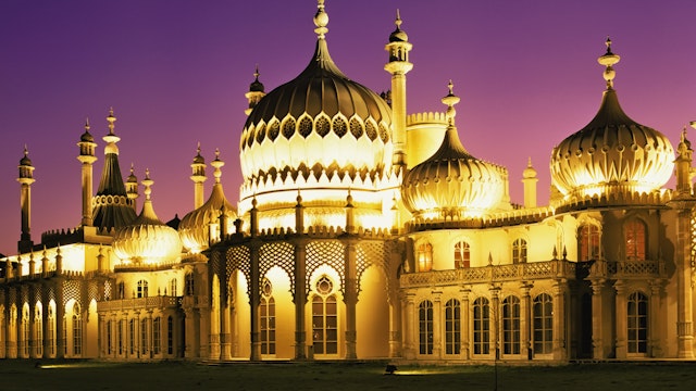 Illuminated Brighton Pavilion building at dusk, Brighton, Sussex, United Kingdom