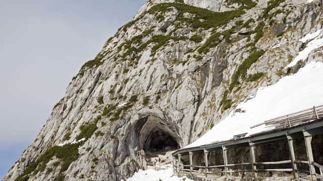 Austria, Werfen, Eisriesenwelt, snow covered building in front of cave