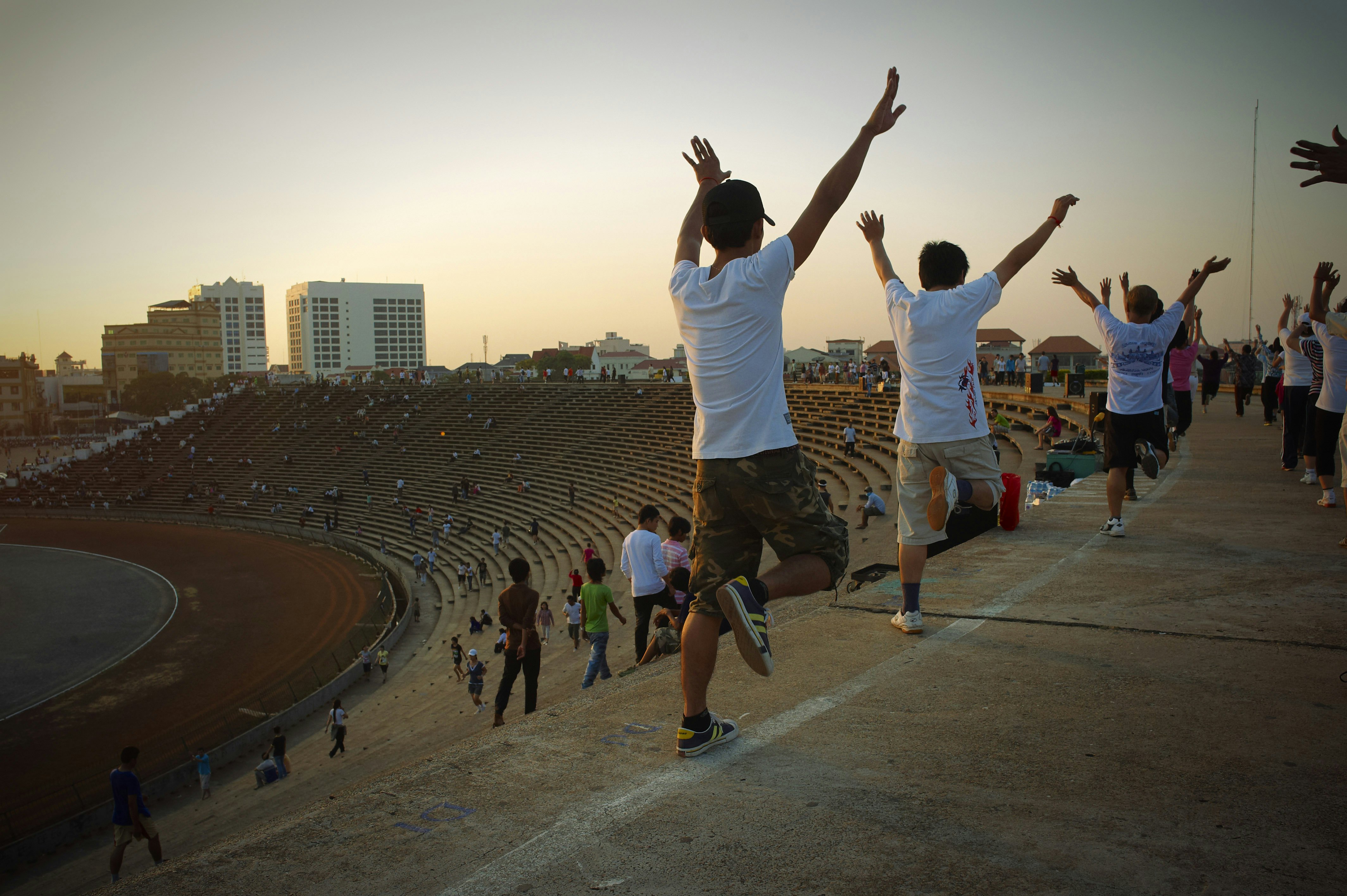 Cambodia, Phnom Penh, Olympic Stadium, popular sports on Sunday. The fastest changing capital city in south east Asia, in it's way of life more then in architectural features. Trendy shops, boutique hotels, colonial restaurants make a new image of the Khmer city. But many shadows and contrasts are left behind, and you can easily see them on the sidewalks.