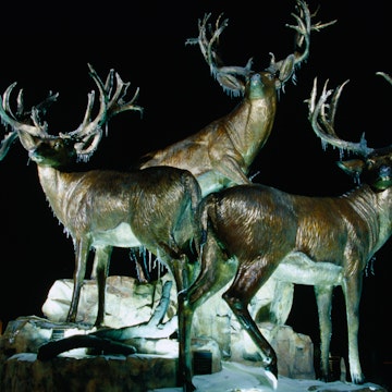Sculpture of three giant mule deer bucks outside Cabela's Store, Village West area.