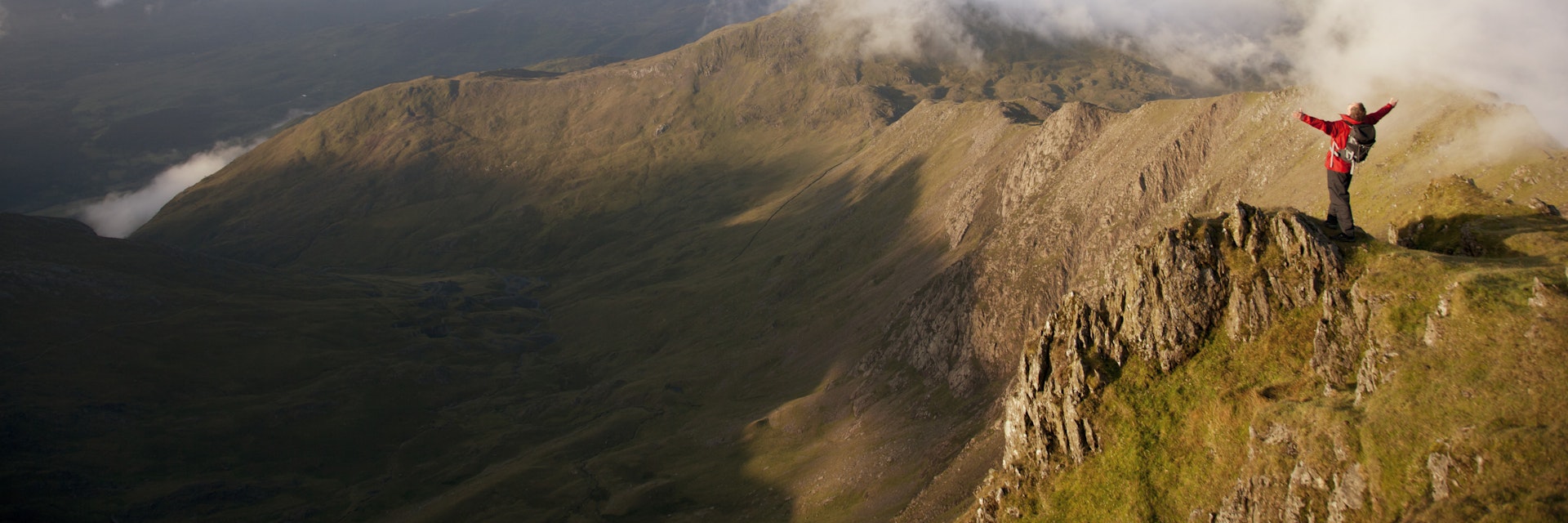 Hiker overlooking view from mountaintop