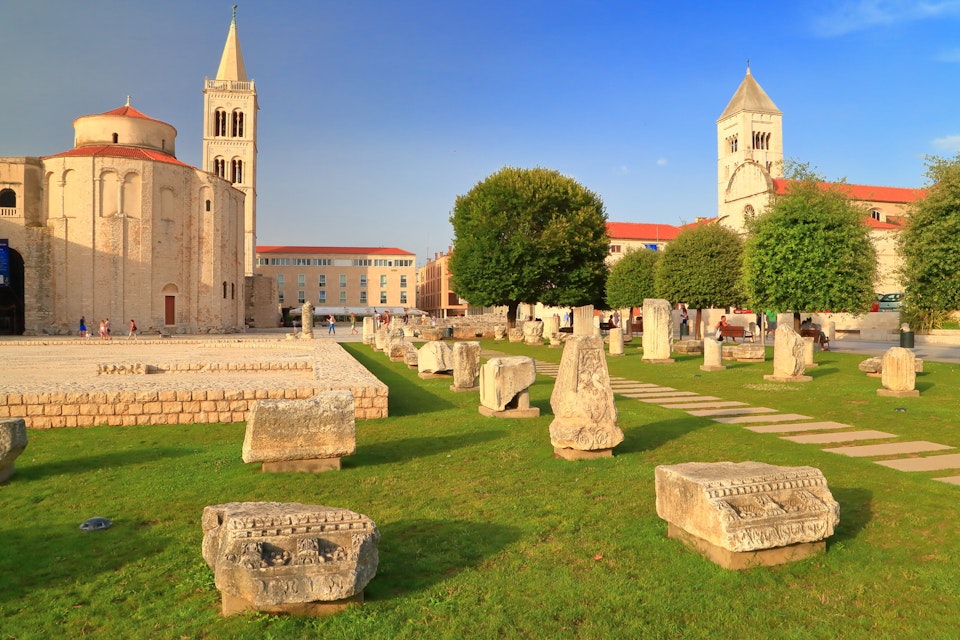 Roman forum and distant church inside old Venetian town, Zadar, Croatia; Shutterstock ID 218654365; Your name (First / Last): Emma Sparks; GL account no.: 65050; Netsuite department name: Online Editorial; Full Product or Project name including edition: Best in Europe POI updates