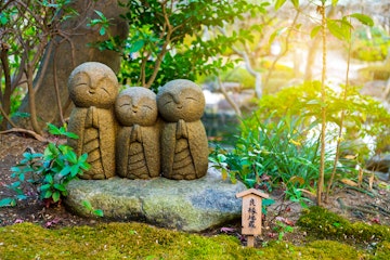 Small smiling stone buddha monk statue (Nagomi Jizo). The Japanese characters mean "The Jizo for good relationship". Hasedera Temple, Kamakura, Japan; Shutterstock ID 539525365; Your name (First / Last): Laura Crawford; GL account no.: 65050; Netsuite department name: Online Editorial; Full Product or Project name including edition: BiA: Takayama, south of Tokyo POI images for online