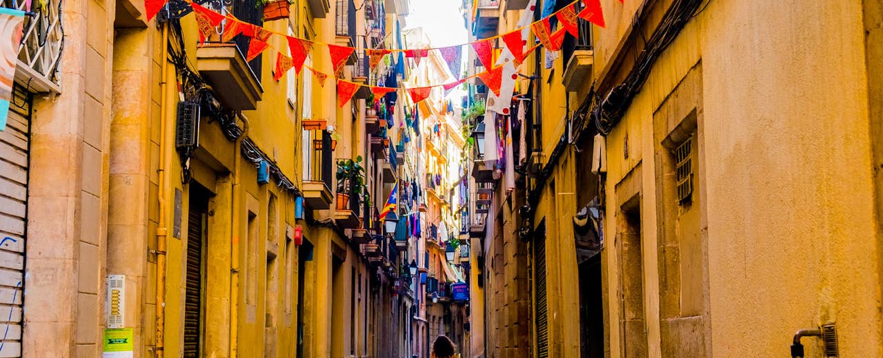 woman walking in old barcelona historic center in spring day