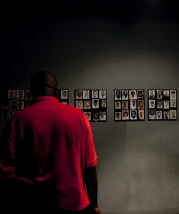 Man viewing photos of victms of genocide at Kigali Memorial Centre.