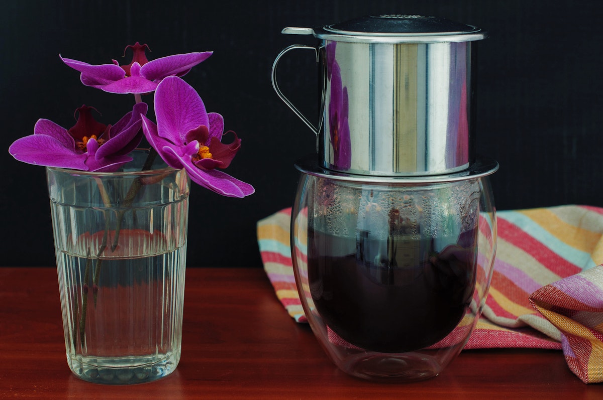 500px Photo ID: 116211643 - Vietnamese coffee and orchid on black background