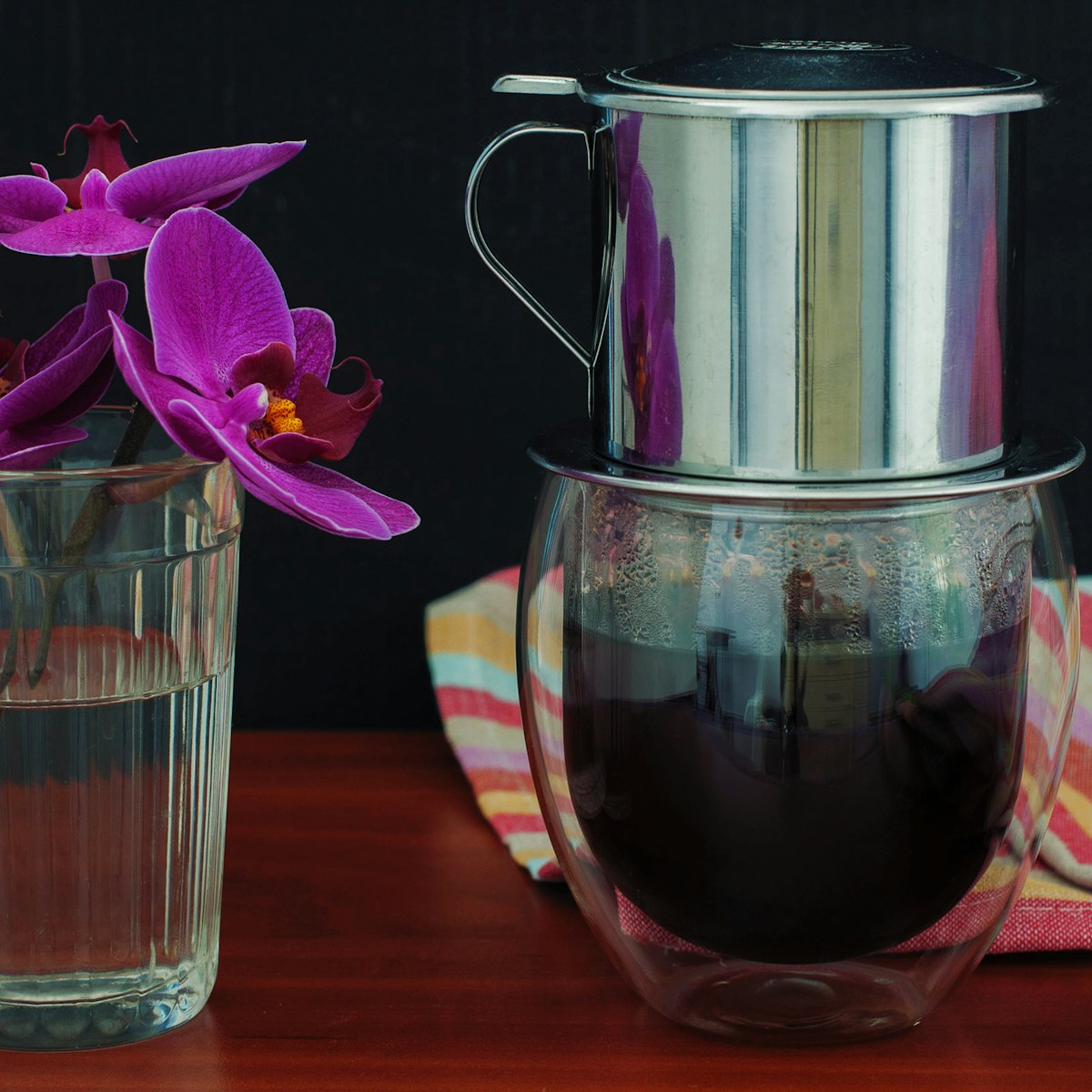 500px Photo ID: 116211643 - Vietnamese coffee and orchid on black background
