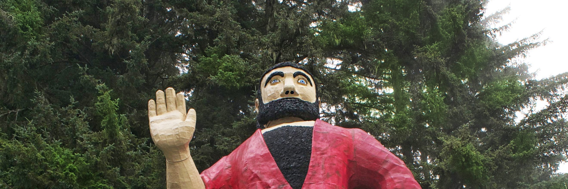 Paul Bunyan in parking lot at the Mystery of Trees. 42 feet tall. Woman at entrance gives a perspective to the size.