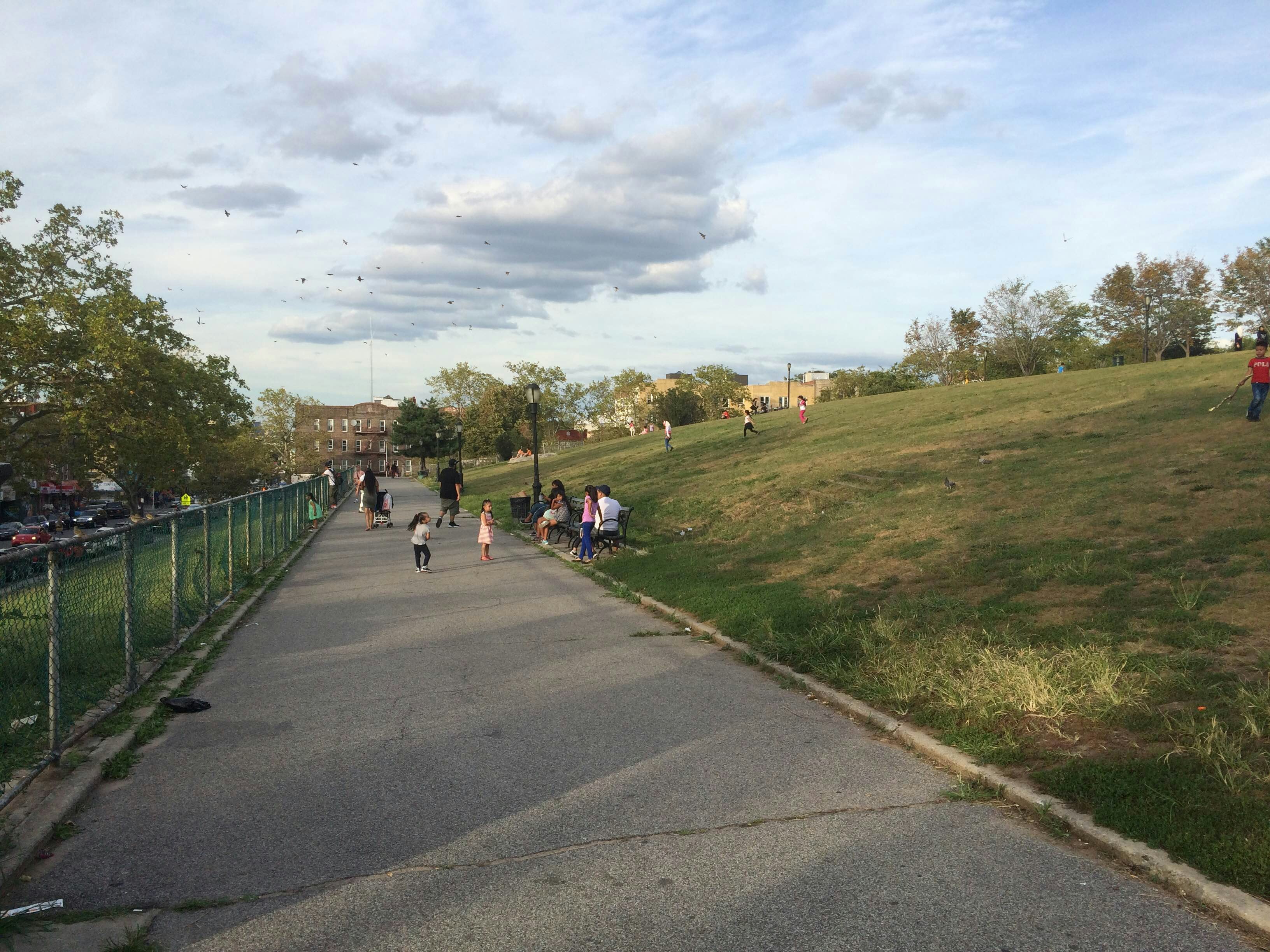Children playing in Sunset Park during the day.