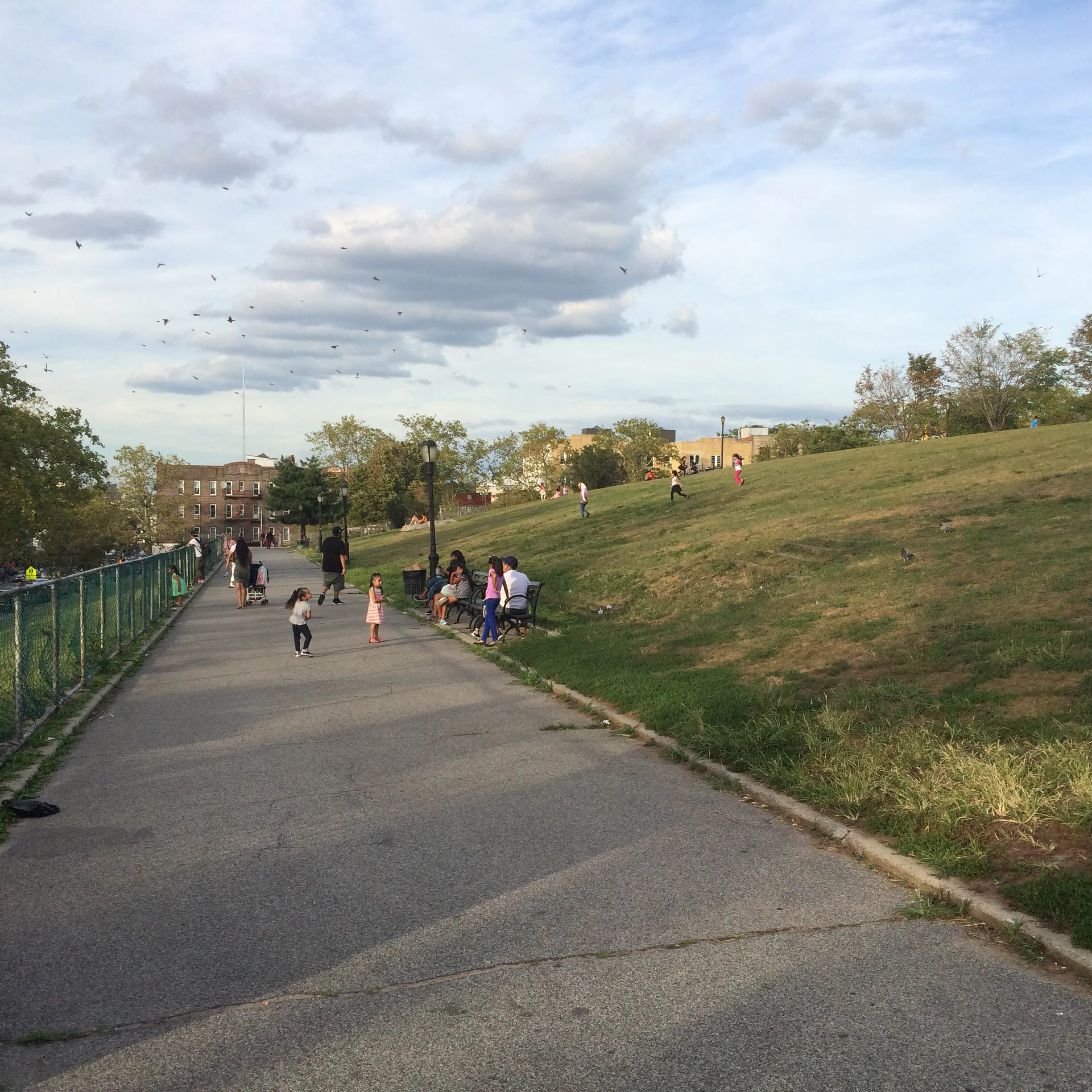 Children playing in Sunset Park during the day.