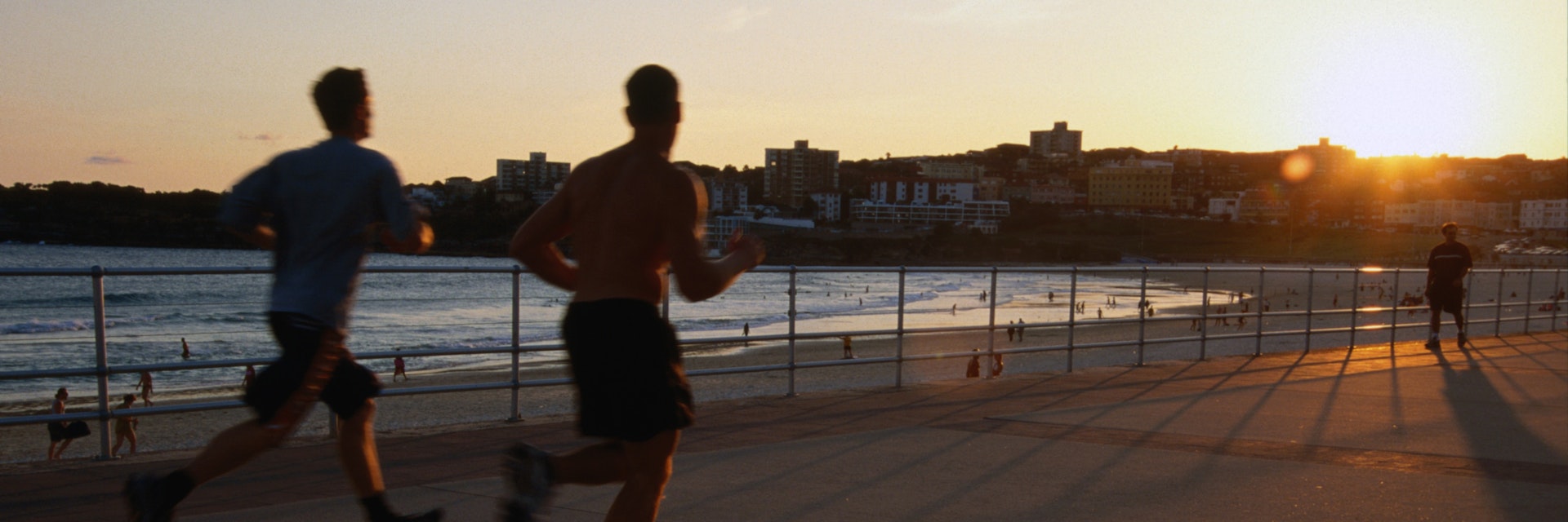 Joggers on promenade at Bondi Beach.