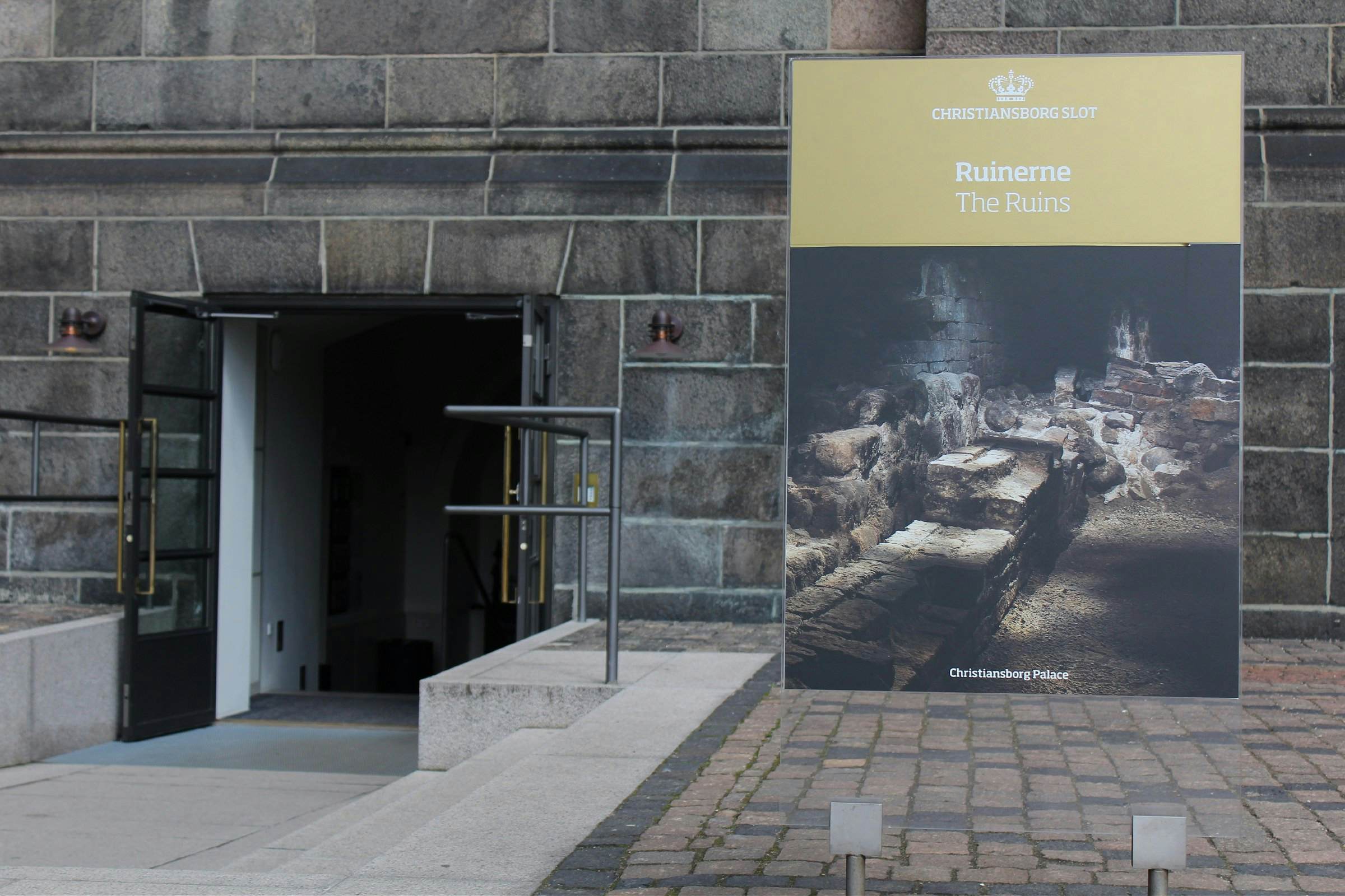 Ruinerne under Christiansborg signage and entrance tight shot