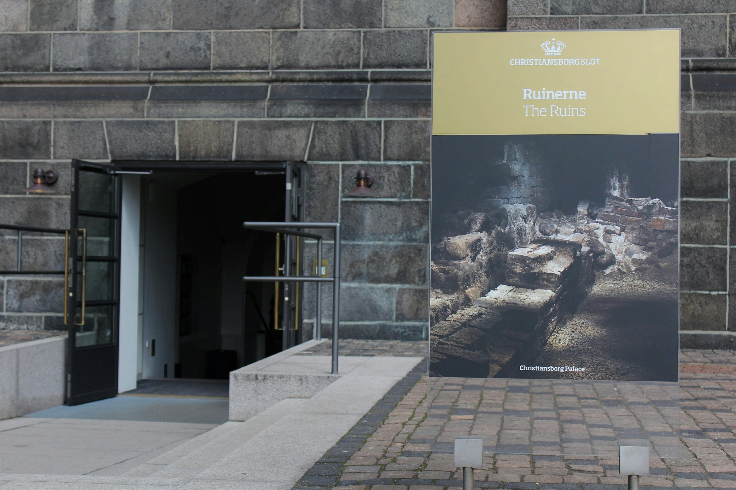 Ruinerne under Christiansborg signage and entrance tight shot
