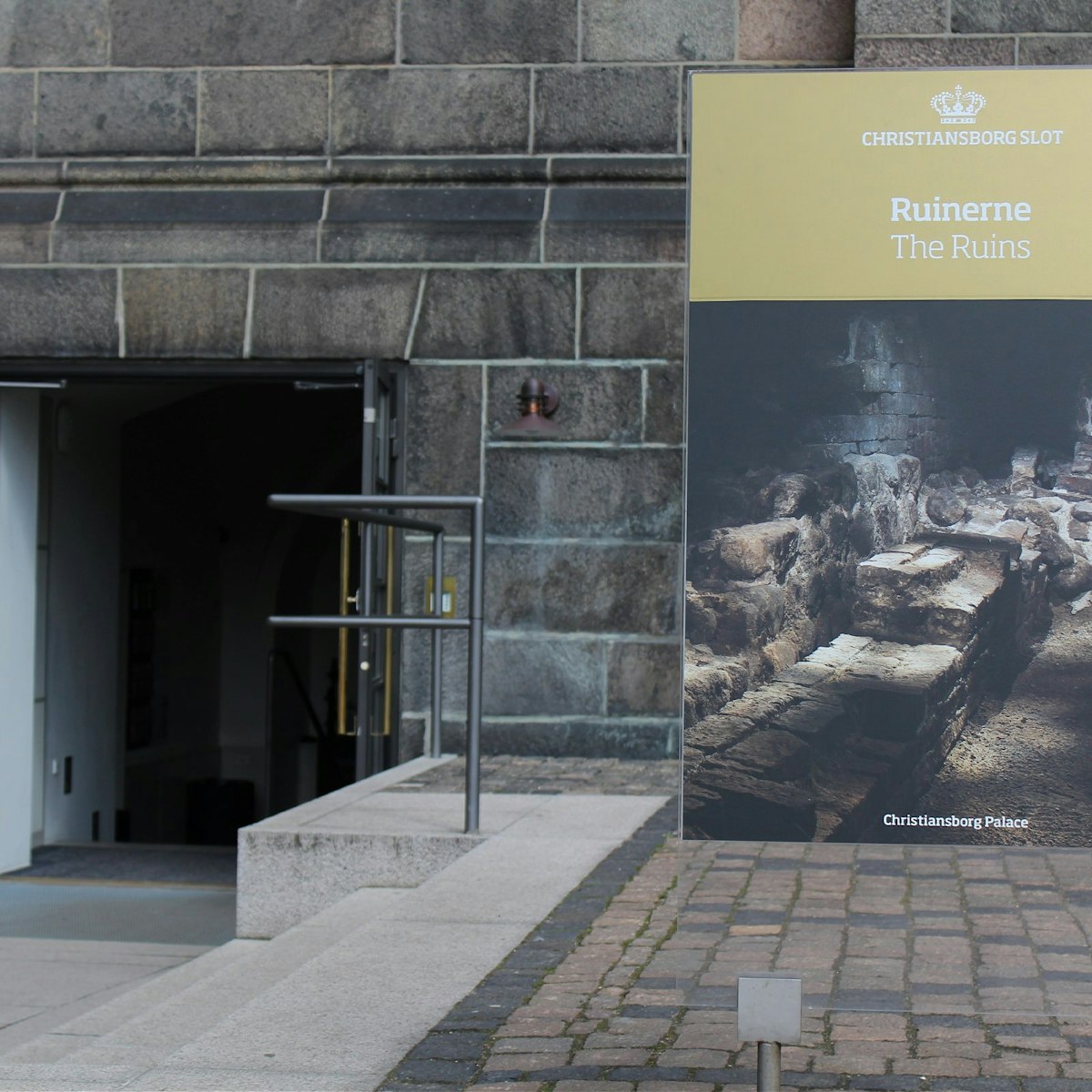Ruinerne under Christiansborg signage and entrance tight shot