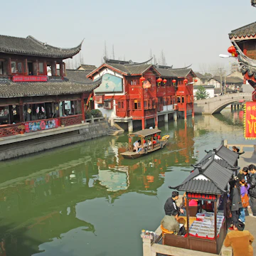 QIBAO, SHANGHAI-MARCH 16, 2010: village canal at sunset. Qibao water village is Shanghai tourist attraction with 1000000 visitors year.; Shutterstock ID 297106160; Your name (First / Last): Lauren Gillmore; GL account no.: 56530; Netsuite department name: Online-Design; Full Product or Project name including edition: 65050/ Online Design /LaurenGillmore/POI