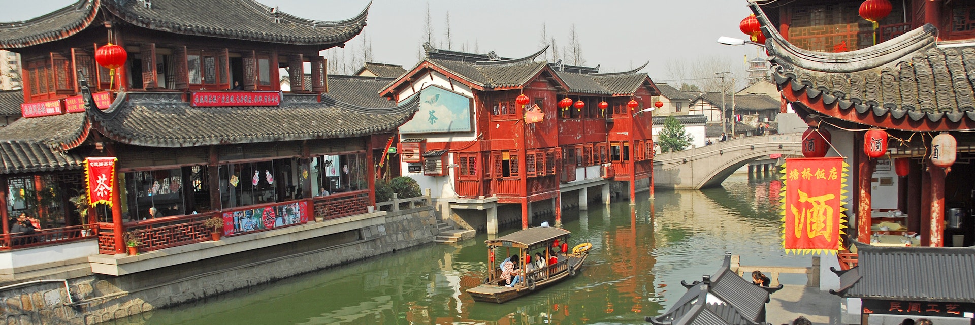 QIBAO, SHANGHAI-MARCH 16, 2010: village canal at sunset. Qibao water village is Shanghai tourist attraction with 1000000 visitors year.; Shutterstock ID 297106160; Your name (First / Last): Lauren Gillmore; GL account no.: 56530; Netsuite department name: Online-Design; Full Product or Project name including edition: 65050/ Online Design /LaurenGillmore/POI