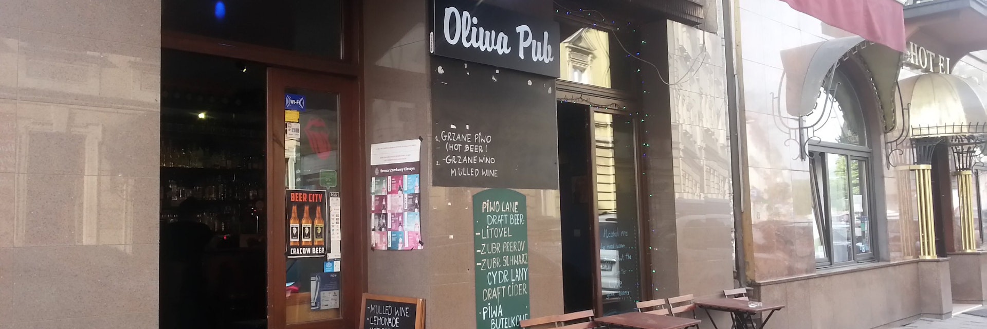 The simple yet inviting exterior of Oliwa Pub along Miodowa Street