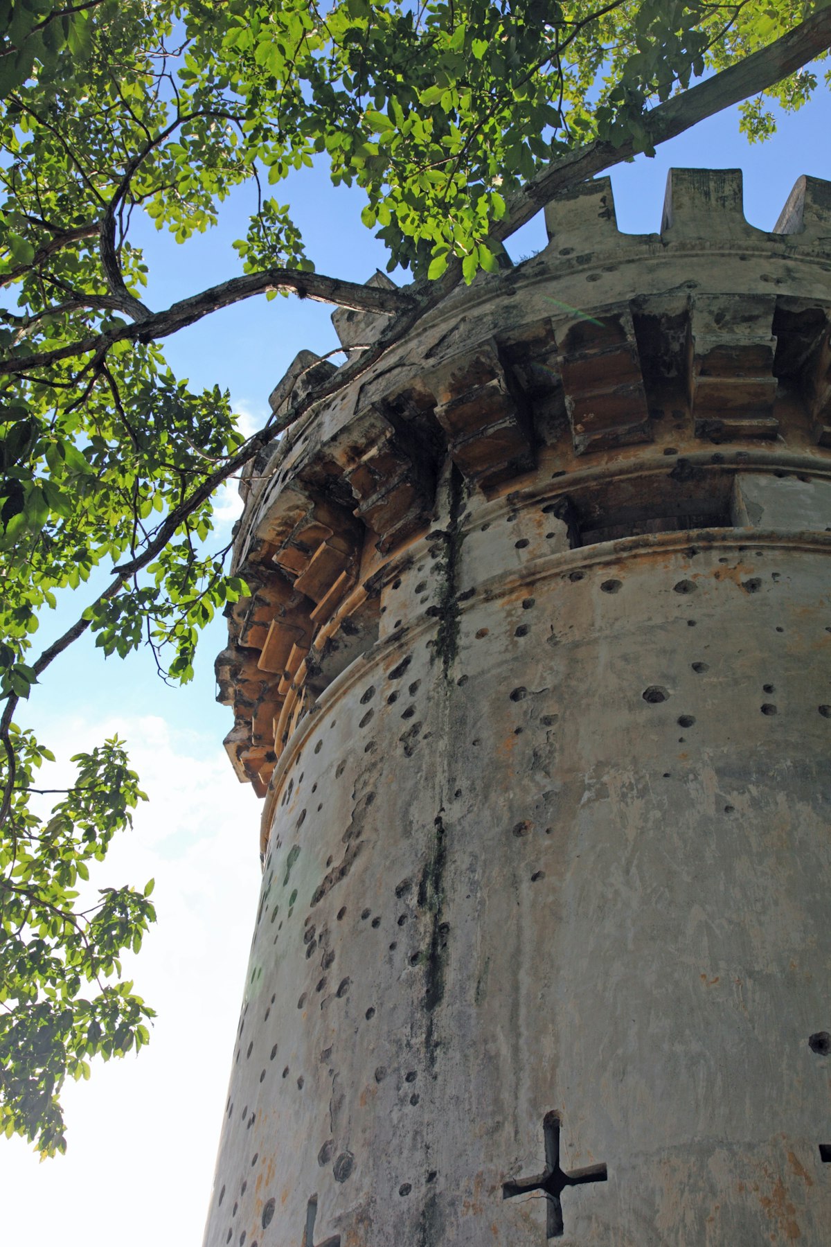 Spanish colonial era tower with battlements and multiple bullet holes, National Museum of Costa Rica.