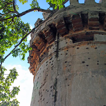 Spanish colonial era tower with battlements and multiple bullet holes, National Museum of Costa Rica.