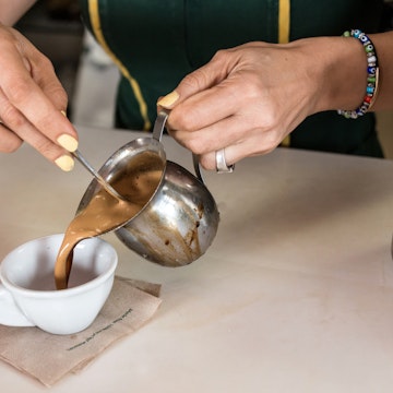 Woman serving a cuban expresso coffee