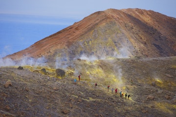 Europe, Italy, Sicily, Aeolian Islands, Vulcano Island,, People walking through fumaroles smoke on Volcano Gran cratere,