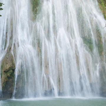 A young man diving off El Limon, the waterfall at Samana, Dominican Republic