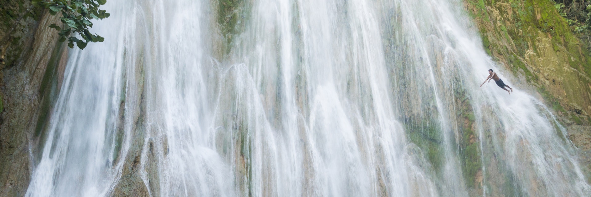 A young man diving off El Limon, the waterfall at Samana, Dominican Republic