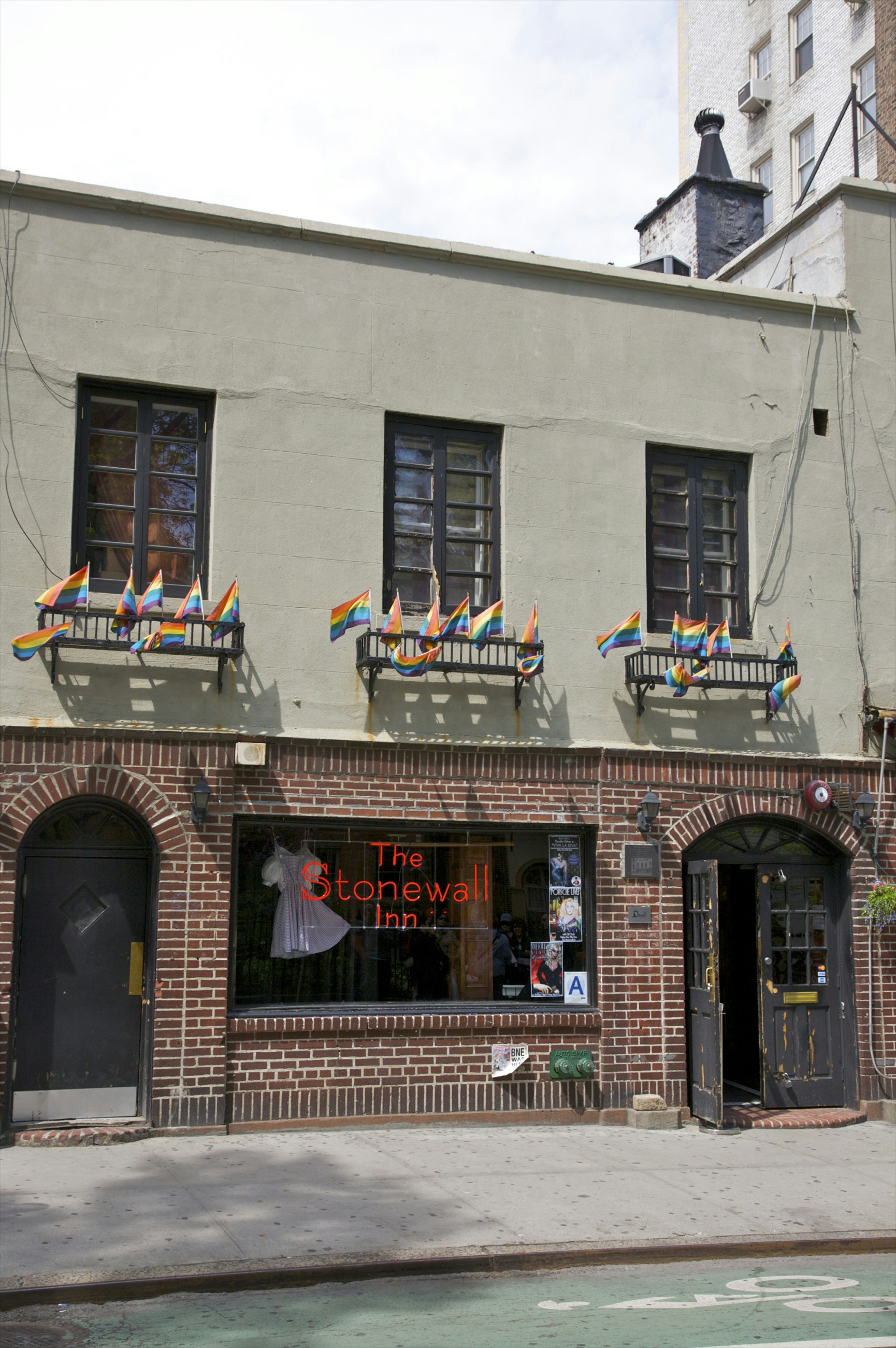 Flags above window with neon sign.