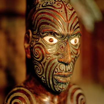 Carved figure on main pole at marae meeting house, Maori and Colonial Museum, Okains Bay, Banks Peninsula, South Island, New Zealand