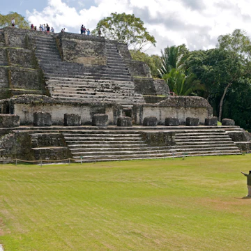 Belize, Belize District, Altun Ha, Tourists in front and on top of the Temple of Masonry Altars in Plaza B of the Mayan ruins A large carved jade head of the Mayan sun god Kinich Ahau was found in the temple.