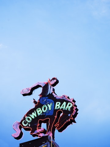Neon sign above Million Dollar Cowboy Bar.